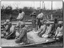 Indian troops praying.  Indian troops served in great numbers at Neuve Chapelle.