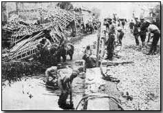 Canadian engineers rebuilding bridge destroyed by retreating Germans